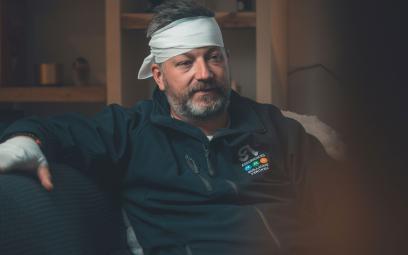 man-with-injury-and-bandage-around-head